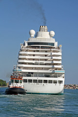 Naklejka premium giant cruise ship for the transportation of passengers pulled by
