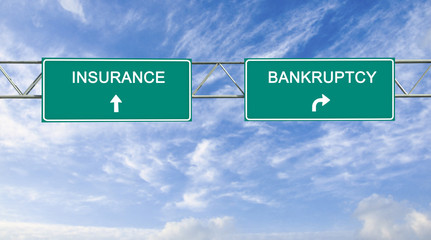 Road sign to insurance and bankruptcy