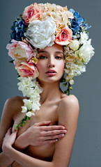 fashion model with large hairstyle and flowers in her hair.