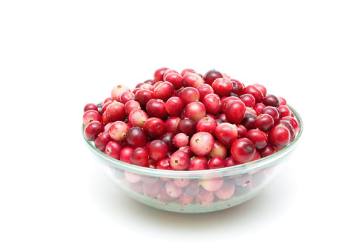 cranberries in a glass bowl on a white background