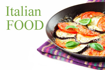 Italian appetizer with tomatoes, eggplant and cheese in a pan
