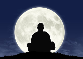 monk in meditation at the full moon