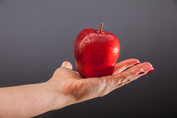Female hand with an apple 