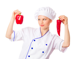 Pretty young woman chef choosing vegetables, red peppers