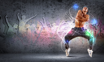 Obraz na płótnie Canvas young man dancing hip hop with color lines