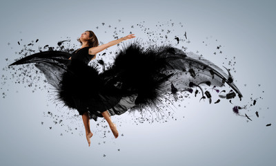 Woman floating   on dark wings
