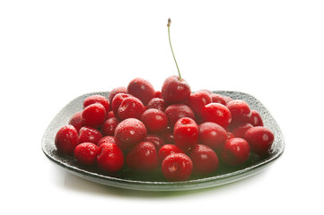 Sweet cherries on black dish