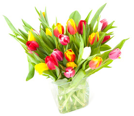 Colorful tulips in a glass vase isolated on a white background
