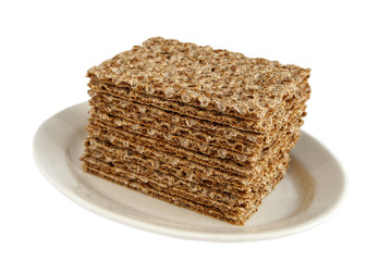 Sesame wholegrain crispbreads on porcelain plate