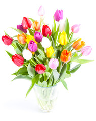 Fototapeta premium Colorful tulips in a glass vase isolated on a white background