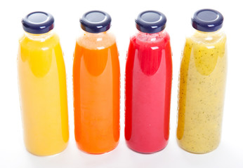 Bottles of fruit juice isolated on white background
