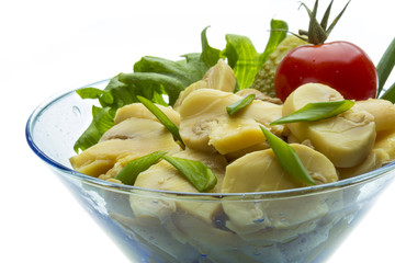 Marinated mushrooms in white saucer isolated on white