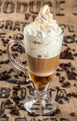 Latte coffee and spilled coffee beans