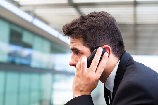 Closeup Portrait Of Handsome Business Man Using Cell Phone At Th