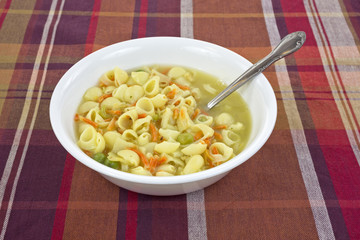 Chicken broth soup with spoon