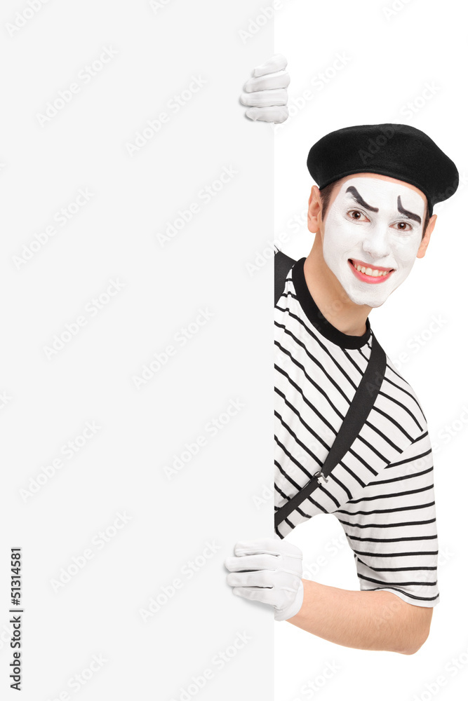 Canvas Prints Smiling mime artist posing behind a blank panel