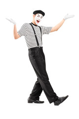 Full length portrait of a male mime dancer gesturing with hands