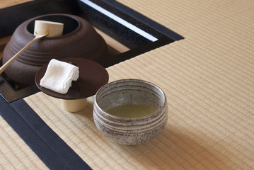 抹茶が入っている日本の畳の茶室にある茶釜とグレーの抹茶茶碗