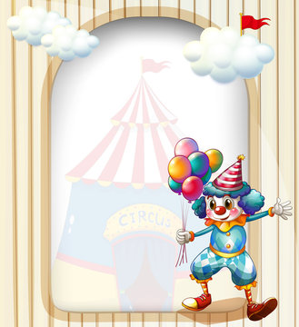 A clown with balloons at the entrance of the carnival