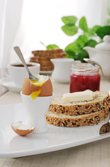 Breakfast with soft-boiled egg and slices of oatmeal bread