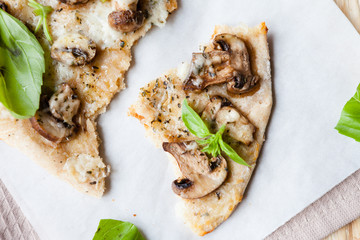 piece of homemade pizza with cheese and mushrooms