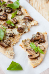 thin homemade pizza with cheese and mushrooms