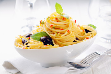 Close up shot of spaghetti pasta in a white bowl