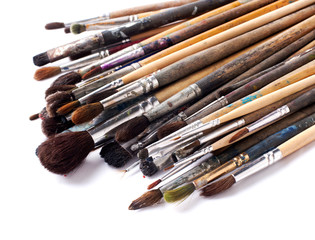 old paint brushes on a white background