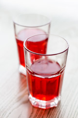 Two red cranberry fruit drinks in glass