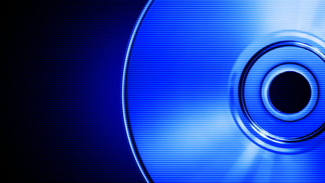 Spinning blue compact disk on a black background (seamless loop)