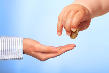 Baby's hand and coin.
