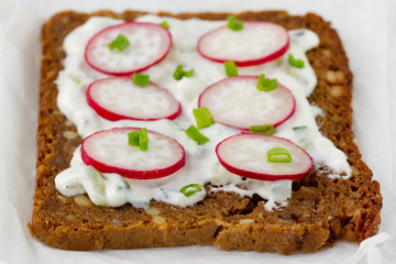 bread with cereals with cheese and radish
