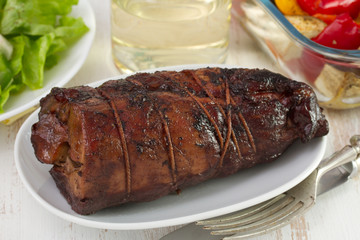 rolled pork with salad and vegetables