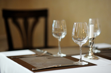 Three wine glasses and a candle