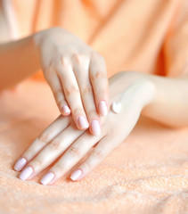 Naklejka premium Beautiful woman hands with cream. Skincare concept