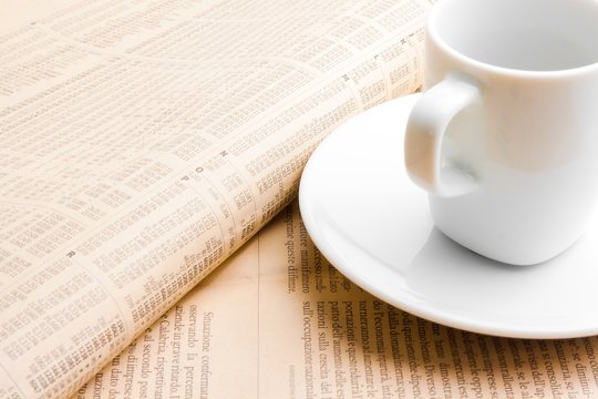 financial newspaper and cup of coffee