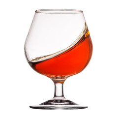 Splash of cognac in glass on white background