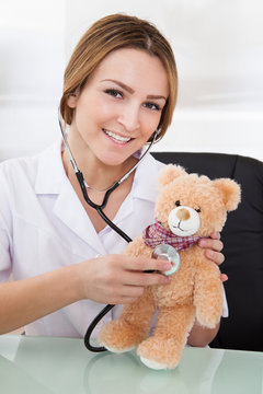 Female Doctor Examining Teddy Bear