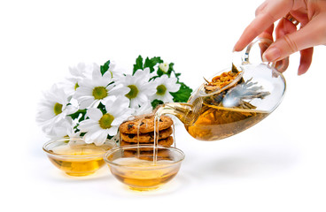 green tea with cookies and flowers on a white background