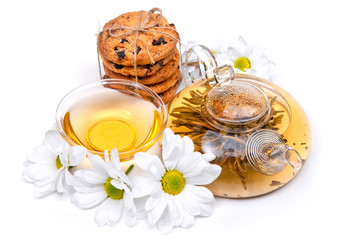 green tea with cookies and flowers on a white background
