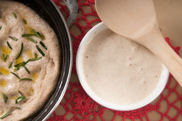 Sourdough in  a white bowl with focaccia bread and doily - 51337961