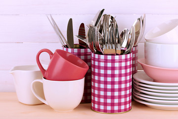 Cups, bowls nd other utensils in metal containers isolated