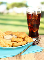 Fried chicken nuggets with french fries,cola and sauce