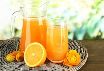 Glass and pitcher of orange juice