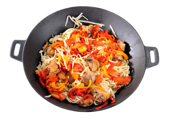 Noodles with vegetables on wok isolated on white