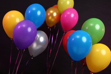 Many bright balloons isolated on black
