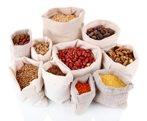 Different kinds of beans in sacks isolated on white
