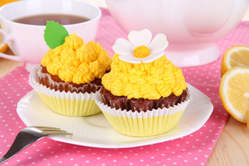 Beautiful lemon cupcakes on dining table close-up