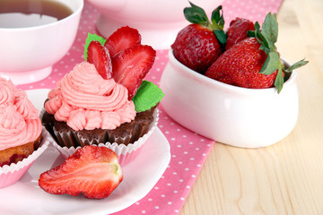 Beautiful strawberry cupcakes and flavored tea