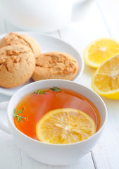 Fresh tea with lemon in the white cup
